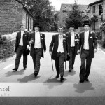 Top hatted lads in black and white shot ambling up country lane in duck-like formation Tim Hensel photographer in Kent