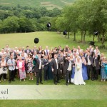 Wedding guests throwing hats into air taken by Tim Hensel photographer in Kent
