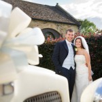 Bride and groom with ribboned vintage car Tim Hensel photographer in Kent