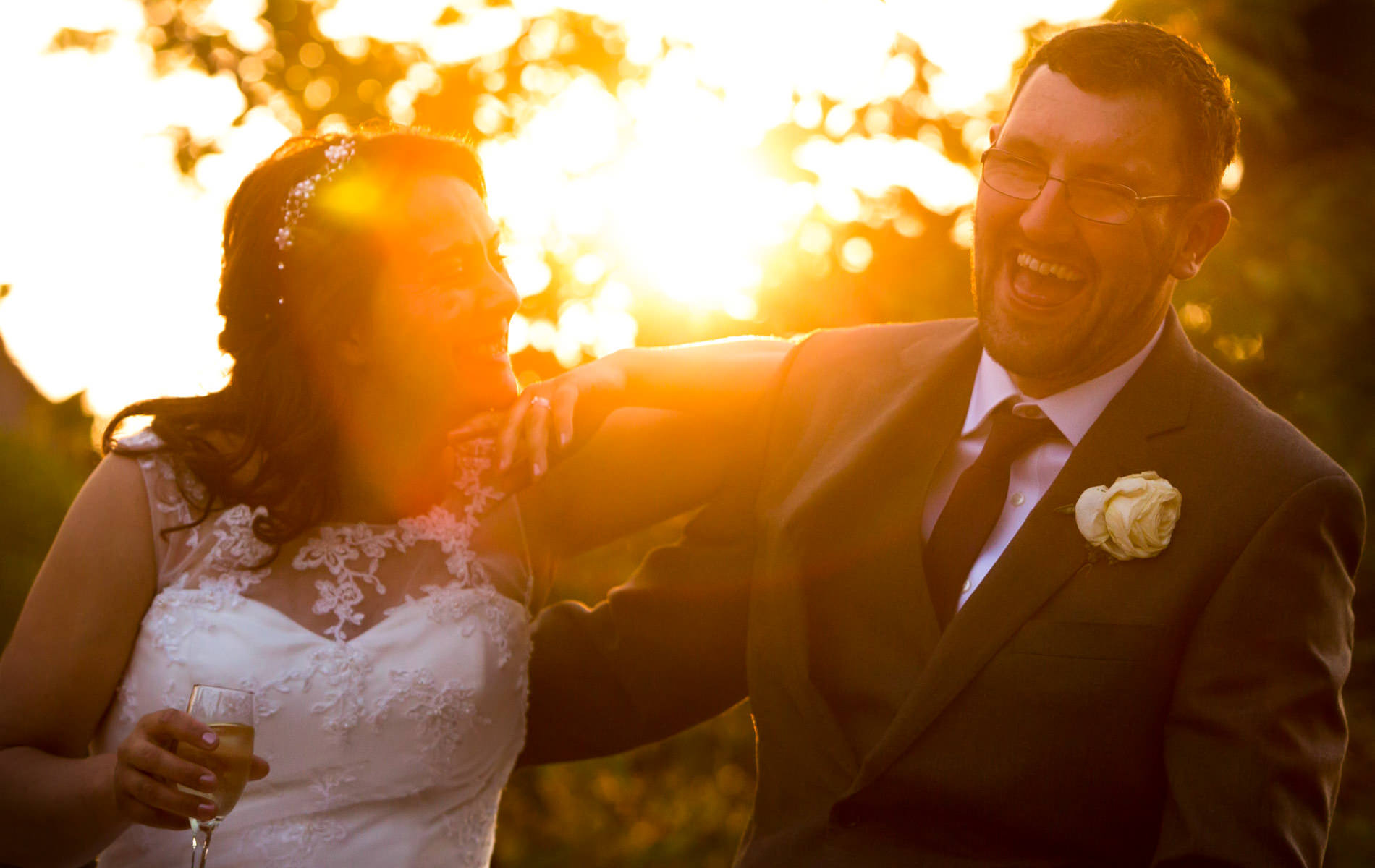 Kent wedding photographer snapping married couple smiling against the sunset