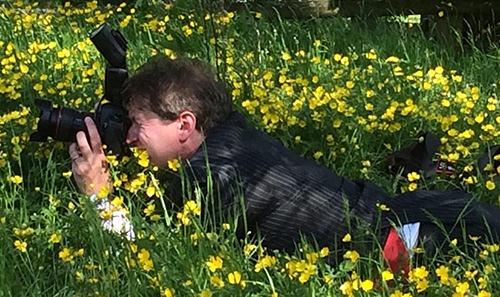 Kent wedding photography Tim Hensel in grass on belly getting perfect shot